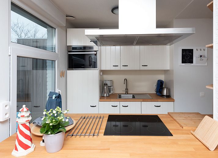 Bright living room in Holiday Home Horizon by the Sea, Renesse, with comfortable seating and views of the garden.