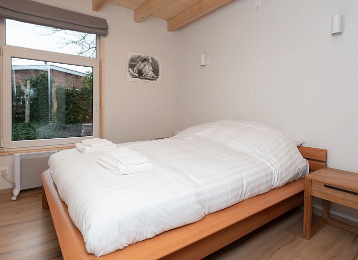 Bright living room in Holiday Home Horizon by the Sea, Renesse, with comfortable seating and views of the garden.