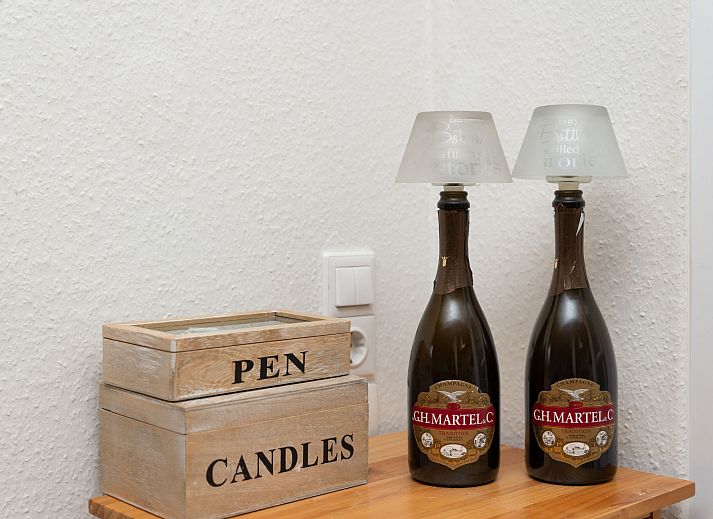 Sunny terrace with deck chairs and fireplace at Holiday home Horizon by the Sea, Renesse, ideal for relaxation.