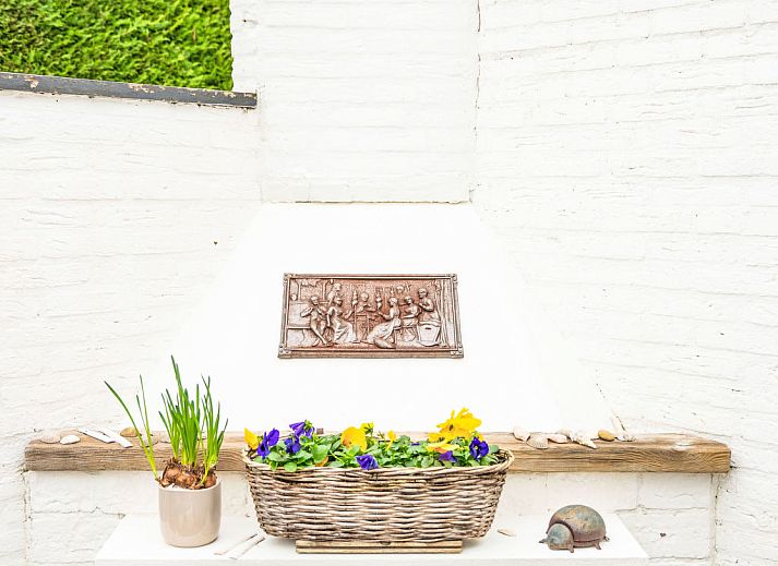Sunny terrace with deck chairs and fireplace at Holiday home Horizon by the Sea, Renesse, ideal for relaxation.