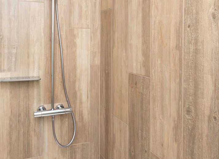 Sunny terrace with deck chairs and fireplace at Holiday home Horizon by the Sea, Renesse, ideal for relaxation.