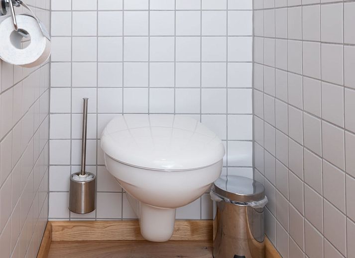 Dining room with wood stove in Holiday home Horizon by the Sea, Renesse, offers a warm and cozy atmosphere.