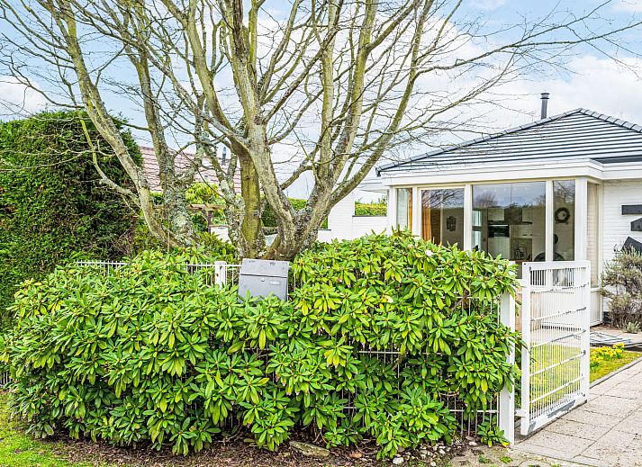 Dining room with wood stove in Holiday home Horizon by the Sea, Renesse, offers a warm and cozy atmosphere.
