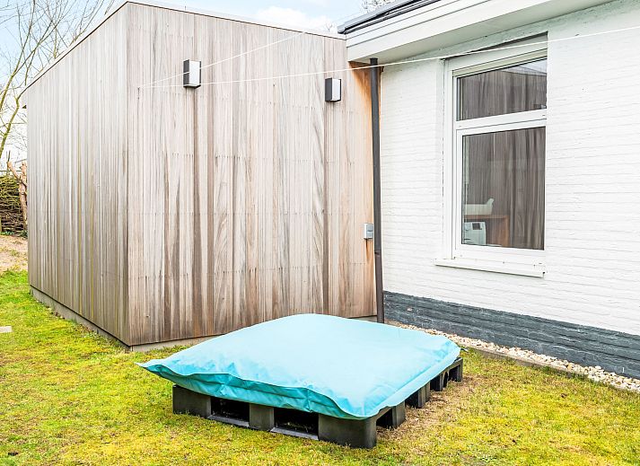 Dining room with wood stove in Holiday home Horizon by the Sea, Renesse, offers a warm and cozy atmosphere.