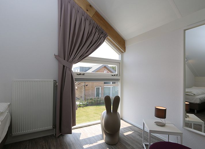 Bright living room of Mon Repos in Renesse with comfortable sofa and modern furnishings