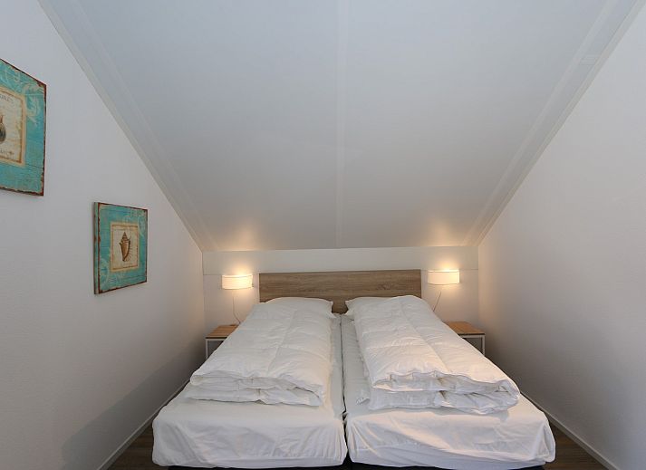 Rueckseite des Ferienhauses Zonnedorp 18, Duinhuis 18 in Renesse, Zeeland mit grosser Terrasse und Rasen.