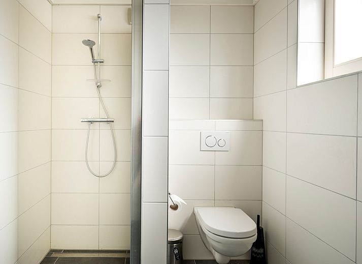 Frontansicht des Ferienhauses Scalde Oort 43 Duinzigt in Westenschouwen, umgeben von viel Gruen in Schouwen-Duiveland, Zeeland.