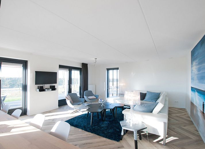 Modern vacation home facade of Oesterdam Resort in Tholen, Zeeland with terrace and seating area.