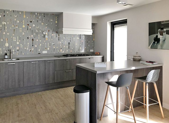 Modern vacation home facade of Oesterdam Resort in Tholen, Zeeland with terrace and seating area.