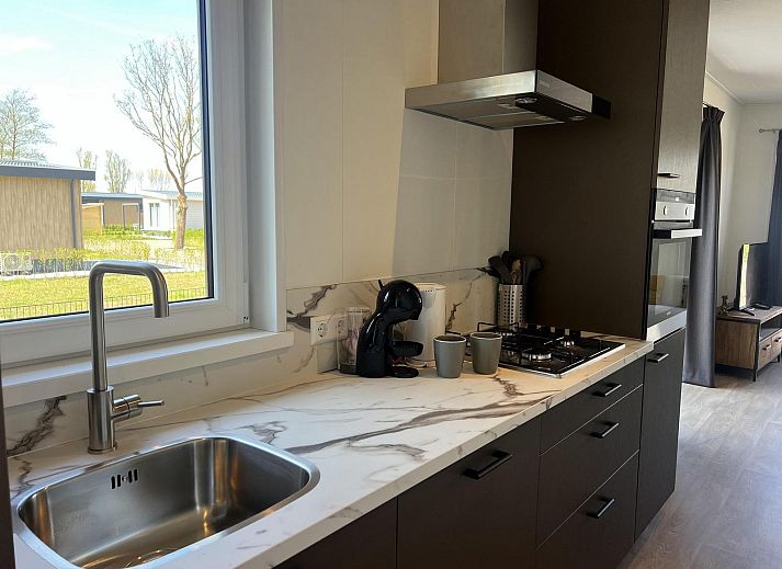 Gezellige woonkamer in VZ2323 Vakantiechalet, Scherpenisse, Zeeland met comfortabele zithoek.