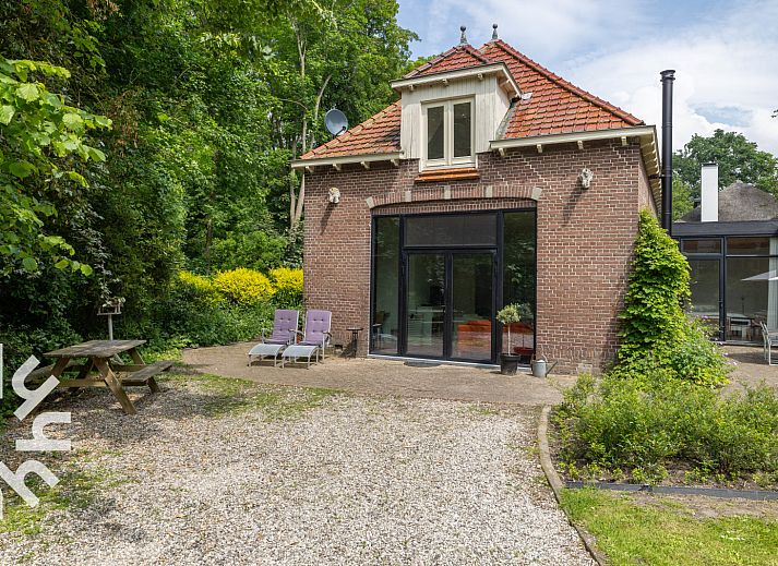 Quiet outdoor area with parasol at vacation home ZE1302 in Koudekerke, Walcheren, Zeeland.