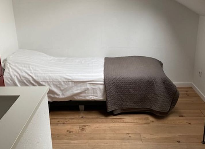 Terrasse im Ferienhaus in Koudekerke, Walcheren, mit Sitzgelegenheit und Blick auf den Garten.