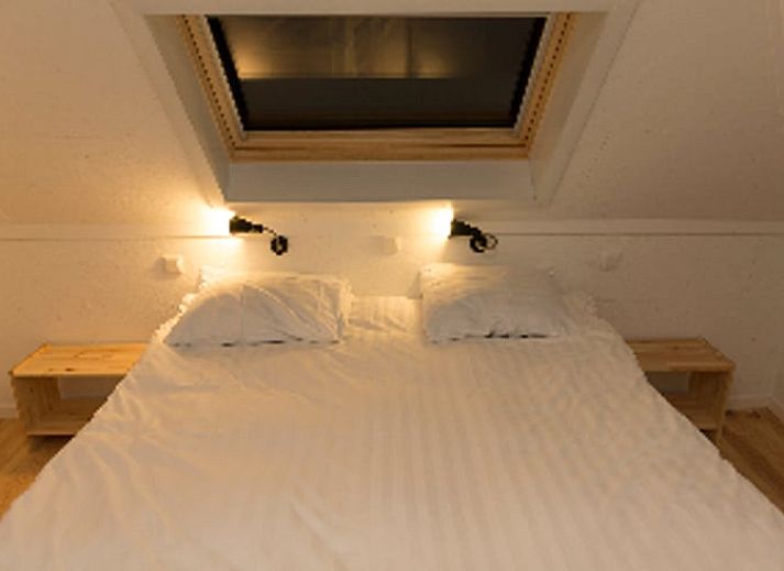 Gemuetlicher Innenbereich des Ferienhauses in Koudekerke, Zeeland, mit Kueche und Sitzecke.