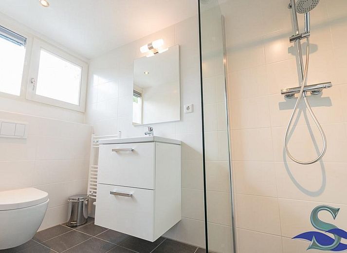 Cozy living room of VZ1157 Detached very spacious vacation home in Oostkapelle with large windows and comfortable sofas.