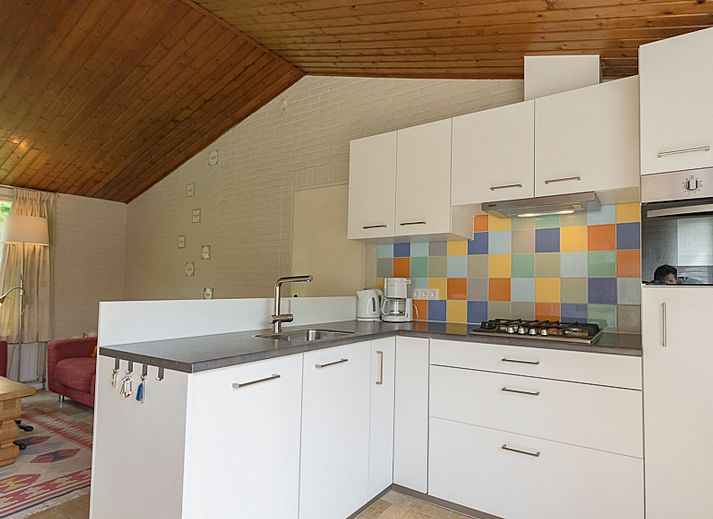 Front of VZ1182 Holiday bungalow in Oostkapelle, Walcheren, surrounded by greenery.