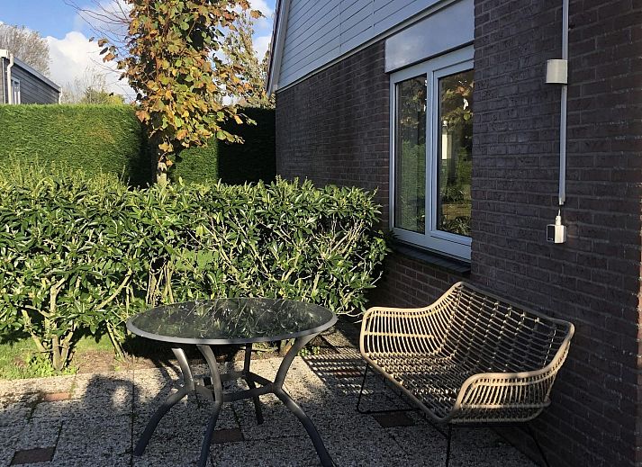 Stilvolle TV-Ecke im Ferienhaus VZ2416, Oostkapelle, Walcheren, mit modernem Flachbildschirm und dekorativer Pflanze.