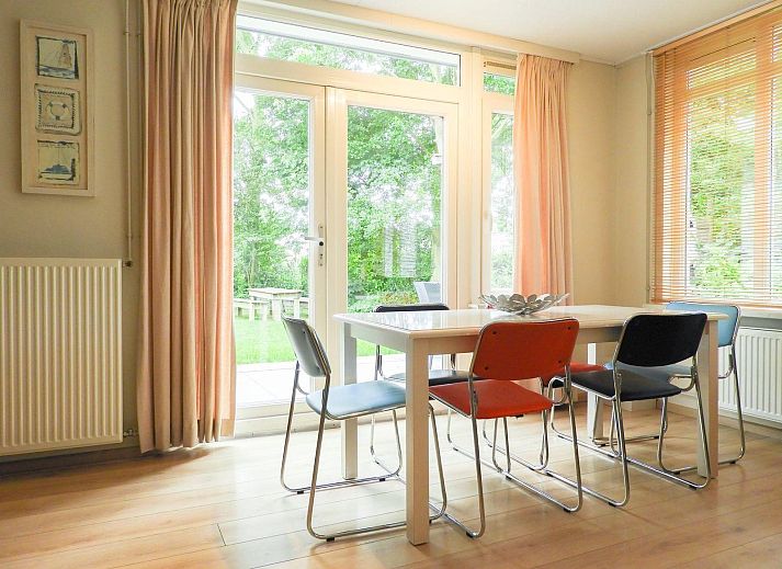 Terrace of VZ073 Holiday bungalow Oostkapelle, Walcheren, Zeeland with garden furniture in sunlight.