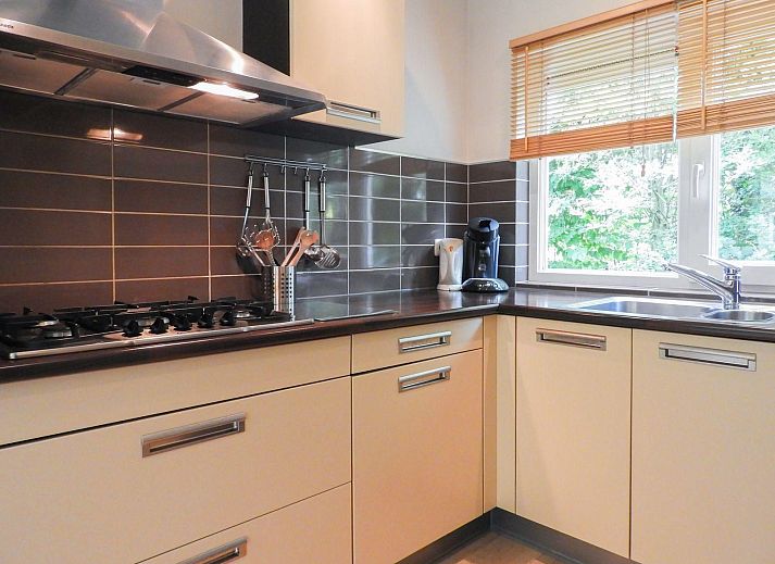 Terrace of VZ073 Holiday bungalow Oostkapelle, Walcheren, Zeeland with garden furniture in sunlight.