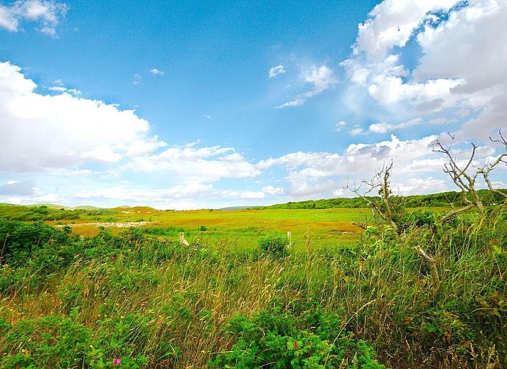 Dining room in VZ073 Holiday bungalow Oostkapelle, Walcheren, Zeeland with garden view.