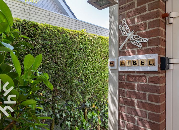 Ingang van vakantiehuis ZE1148 in Oostkapelle, Walcheren, met groene omheining en decoratie.