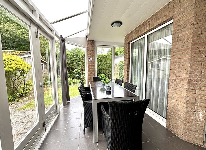 Cozy conservatory in Apartment Boszicht 1, Oostkapelle, Walcheren, overlooking the garden.