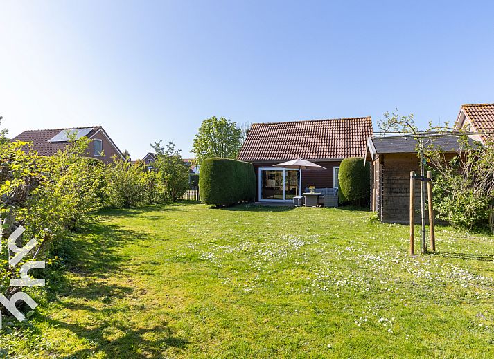 Cozy corner with table and chair in vacation home ZE414, Oostkapelle, Walcheren, Zeeland.