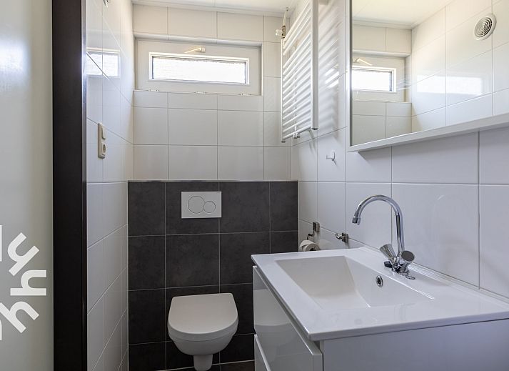 Cozy corner with table and chair in vacation home ZE414, Oostkapelle, Walcheren, Zeeland.
