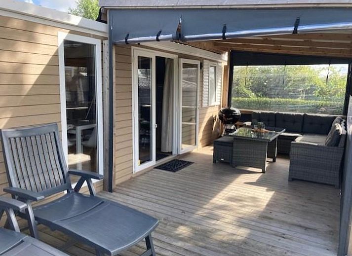 VZ2332 Vakantiechalet in Oostkapelle, Walcheren, Zeeland met zonnige veranda en grasveld.