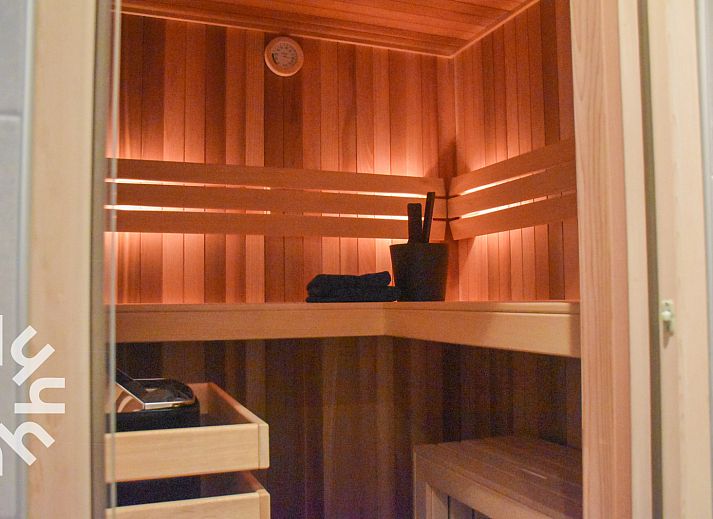 Exterior of vacation home ZE1315 in Westkapelle, Walcheren, Zeeland with red roofs and sunny street.