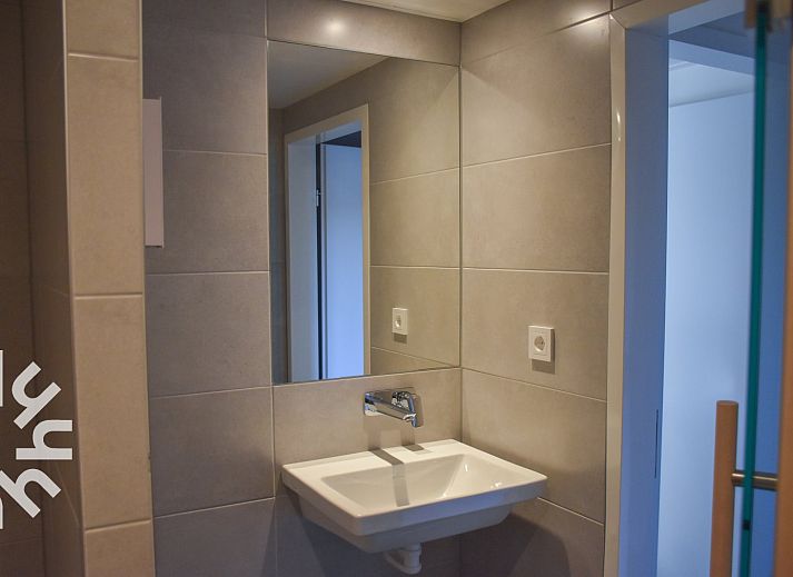 Exterior of vacation home ZE1315 in Westkapelle, Walcheren, Zeeland with red roofs and sunny street.