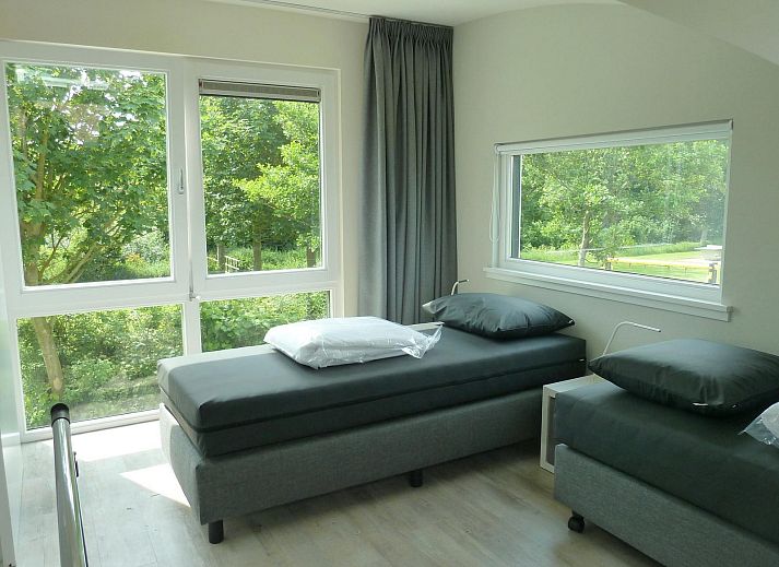 Terrasse von VZ1139 Freistehendes Ferienhaus in Vlissingen, Walcheren mit Gartensitzplatz und Sonnenschirm.