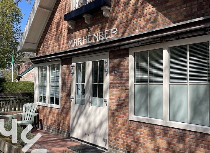 Attractive bedroom in vacation home ZE1541, Zoutelande, Walcheren with comfortable bed and view of green garden.