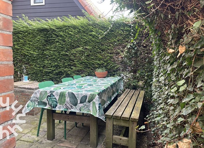 Attractive bedroom in vacation home ZE1541, Zoutelande, Walcheren with comfortable bed and view of green garden.