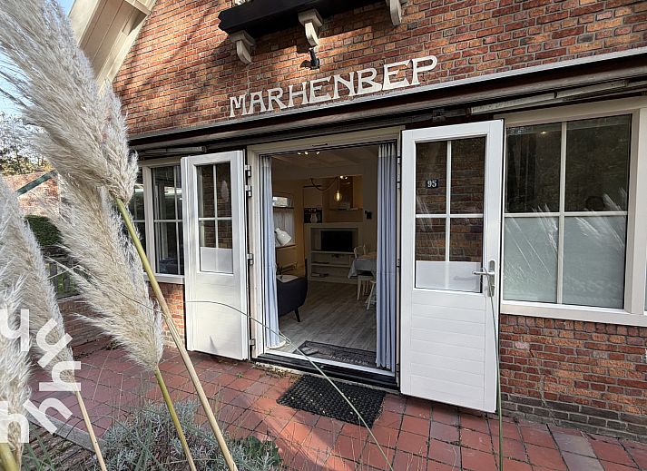 Attractive bedroom in vacation home ZE1541, Zoutelande, Walcheren with comfortable bed and view of green garden.