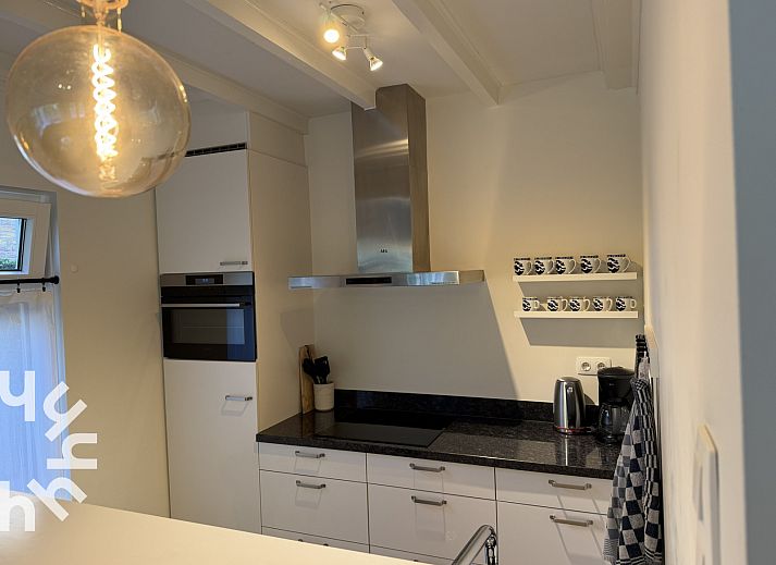 Attractive bedroom in vacation home ZE1541, Zoutelande, Walcheren with comfortable bed and view of green garden.