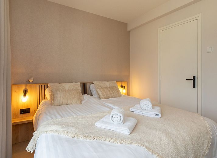 Sfeervolle slaapkamer in Appartement Kurhaus Residence, Zoutelande, Walcheren, Zeeland met comfortabel tweepersoonsbed.