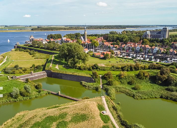 Sunny terrace at vacation home ZE1151 in Veere, Walcheren, Zeeland, ideal for outdoor meals.