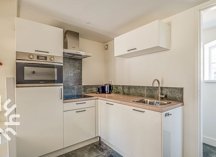 Sunny terrace at vacation home ZE1151 in Veere, Walcheren, Zeeland, ideal for outdoor meals.