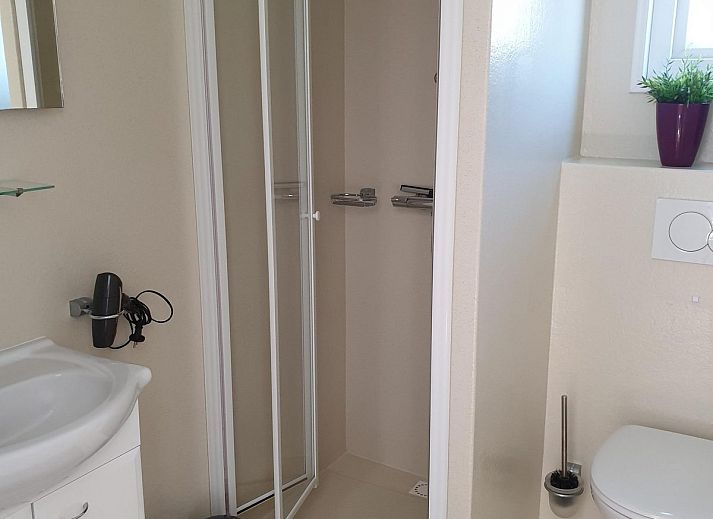 Cozy terrace at VZ814 Chalet in Veere, Serooskerke, Walcheren, with comfortable seating and floral displays.