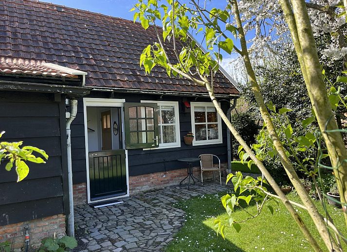 Charming entrance to VZ2412 Holiday home Serooskerke in Walcheren, Zeeland, surrounded by greenery.
