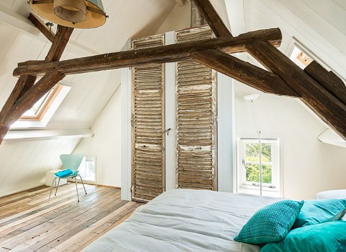 Cozy terrace at Mariekerke vacation home in Meliskerke, Walcheren, with ample seating and green surroundings.