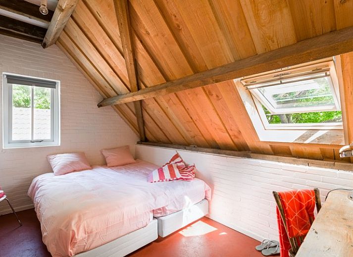 Cozy terrace at Mariekerke vacation home in Meliskerke, Walcheren, with ample seating and green surroundings.