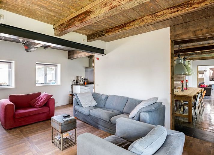 Cozy terrace at Mariekerke vacation home in Meliskerke, Walcheren, with ample seating and green surroundings.