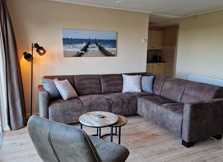 Cozy living room of Vakantiewoning Meidoorn in Meliskerke, Walcheren. Comfortable seating area overlooking the garden.