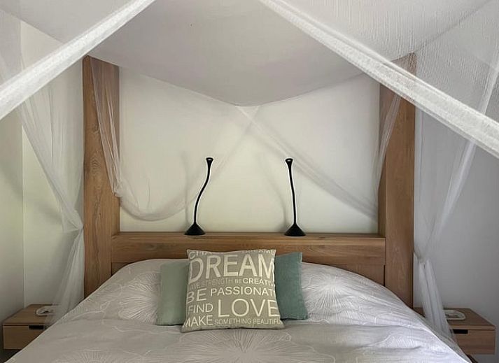 Groene tuin met hangmat en kip bij Vakantiehuisje in Biggekerke, Walcheren, Zeeland.