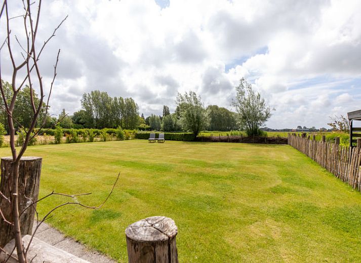 Bloemrijke tuin van Vakantiehuis De kleine Pionier in Grijpskerke, Walcheren, Zeeland met uitzicht op de natuur.
