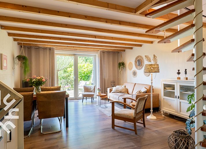 Bedroom with two beds in vacation home ZE833, Buttinge, Walcheren, under a sloping roof.