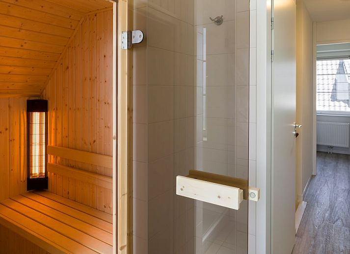 Gemuetliches Wohnzimmer im V8 Luxus-Ferienhaus in Nieuwvliet-Bad, Zeeland, mit komfortabler Sitzecke.