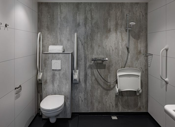 Gezellige woonkamer in Mindervalide 4 vakantiehuis, Nieuwvliet-Bad, Zeeuws-Vlaanderen met moderne inrichting en veel natuurlijk licht.