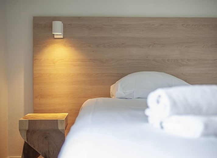 Sfeervolle slaapkamer in Villa 8B Luxe, een vakantiehuis in Cadzand-bad, Zeeuws-Vlaanderen, met rustgevend stranddecor aan de muur.